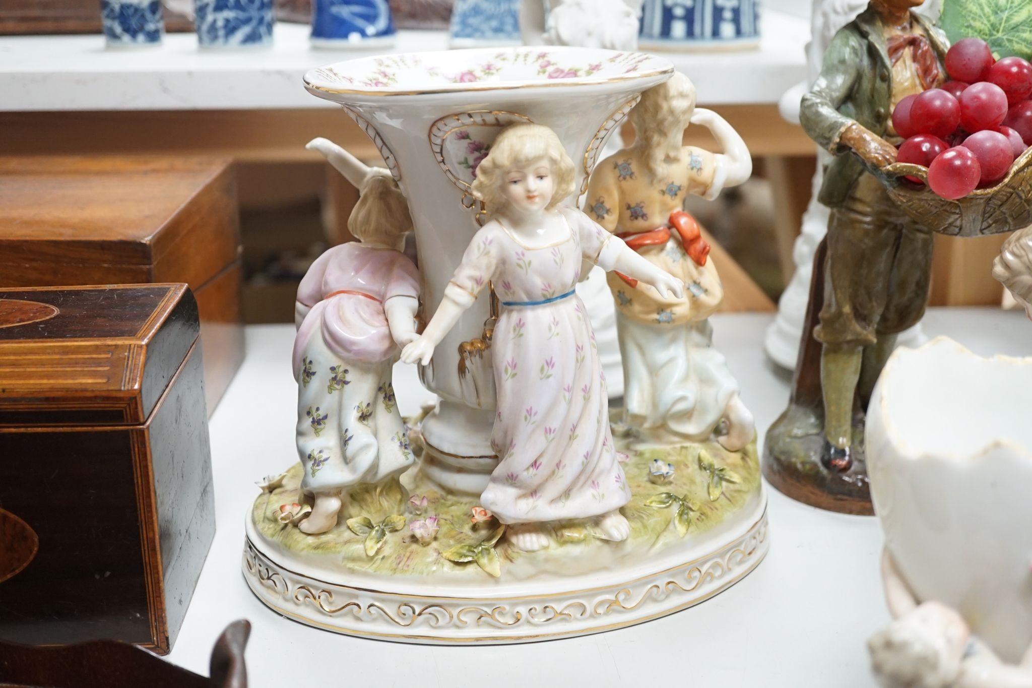 A group of Continental porcelain and pottery figural vases and centrepieces and two candelabra